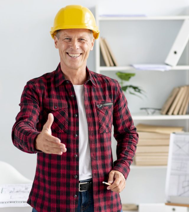 man-wearing-safety-helmet-giving-hand-shake